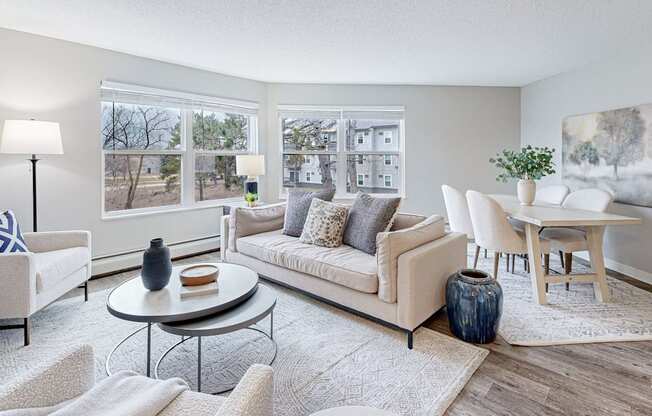 a living room with a couch and chairs and a table