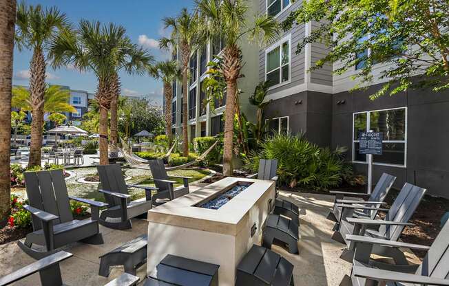 a patio with chairs and a fire pit