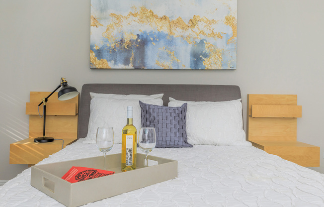 a bedroom with a bed and a table in a room