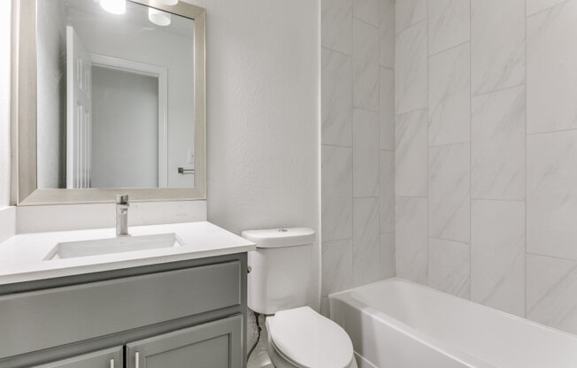 a bathroom with a sink toilet and bathtub