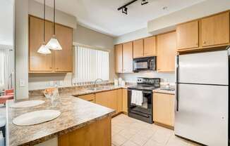 full kitchen with granite counter tops and stainless steel appliances