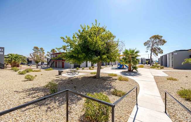 a courtyard with a tree and benches in front of a building