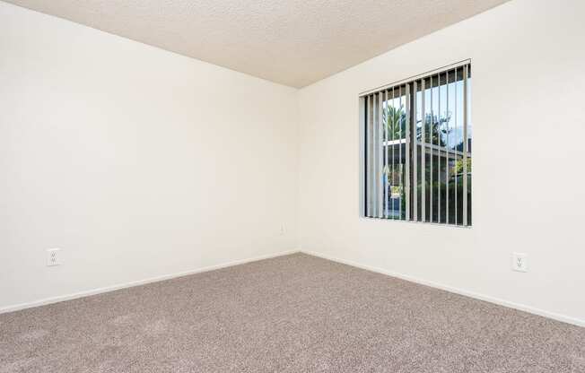 Bedroom with Carpet and Spacious Window at Woodbend, Alta Loma, California