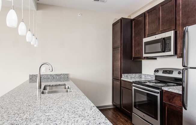 a kitchen with granite counter tops and stainless steel appliances