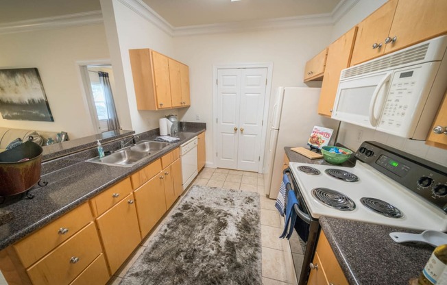 a kitchen with cabinets and a stove and a sink