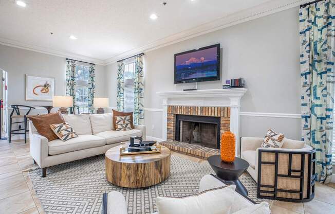 A living room with a fireplace and a television on the wall.