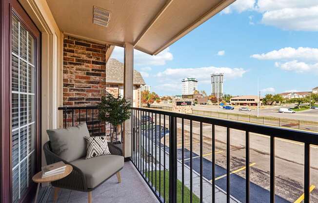 A balcony with a chair and a table.