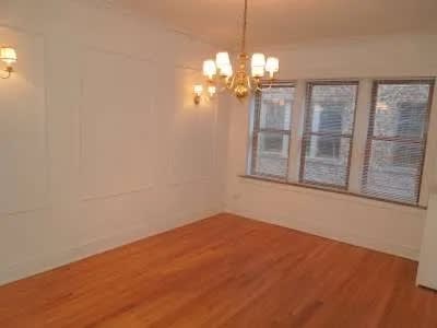Living room with a wood floor and a window at Bryant II