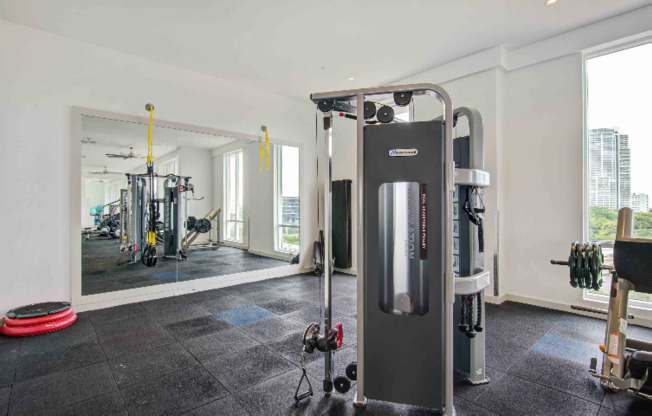 An exercise machine by a mirror in a Miami apartment gym.