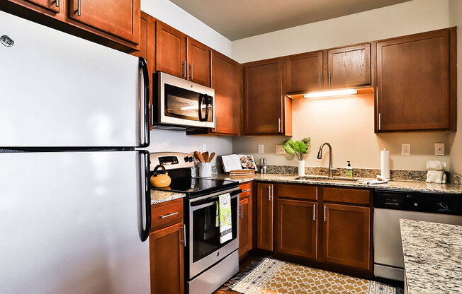 Kitchen with Fridge at Residences at The Streets of St. Charles, St. Charles, Missouri
