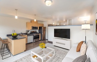 a living room with a couch and a table with a television