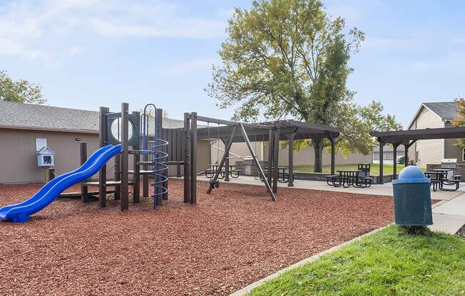 our playground is equipped with a swing set and picnic tables