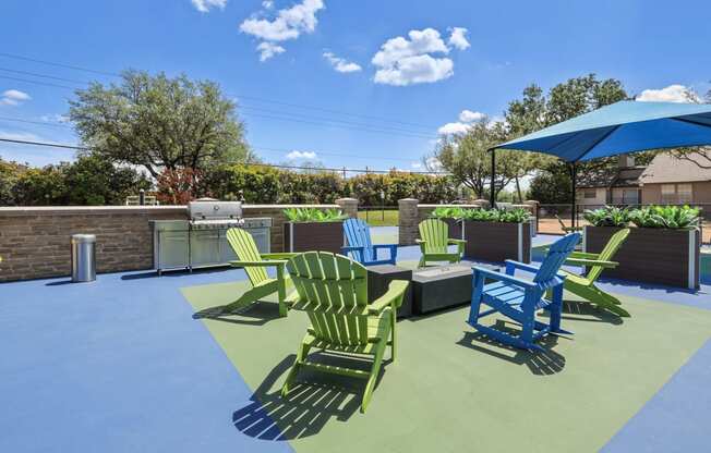 a patio with green and blue chairs and a bbq grill