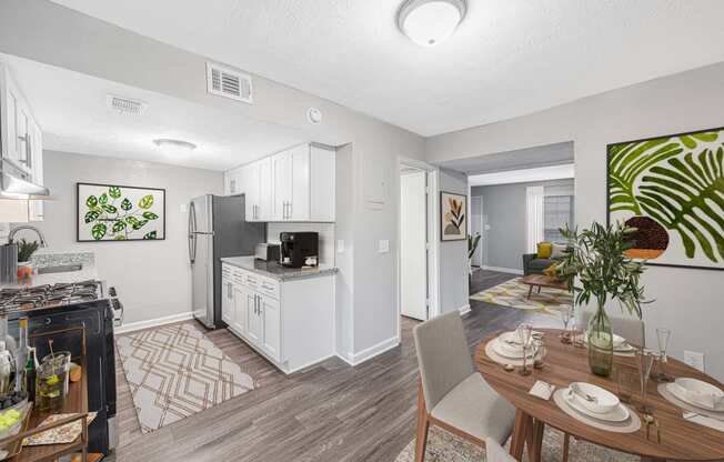 an open kitchen and living room with a dining table