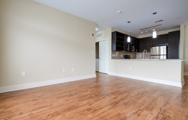 a living room and kitchen with hardwood floors