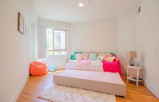 A bedroom with a large bed and a pink blanket at Woodley Sara Apartment, Van Nuys, CA, 91406