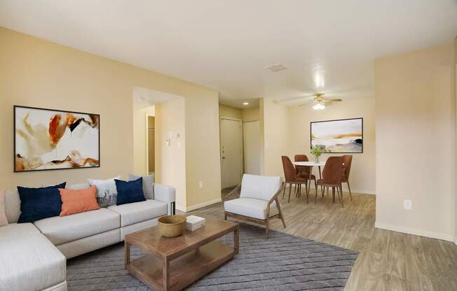 A living room with a white couch and a coffee table.