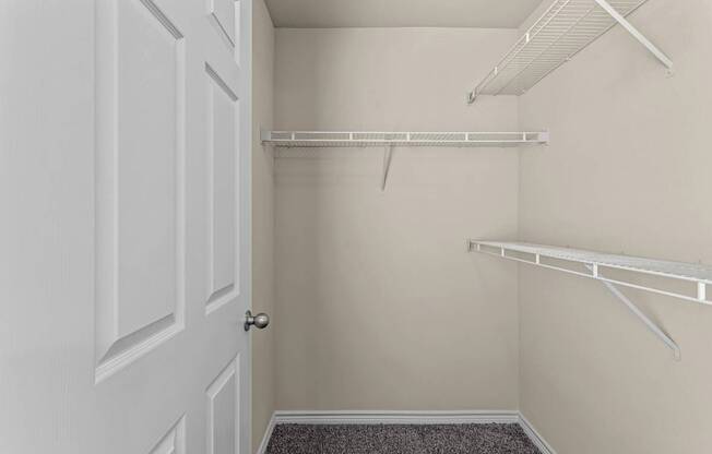A white door is on the left and a white shelf is on the right.