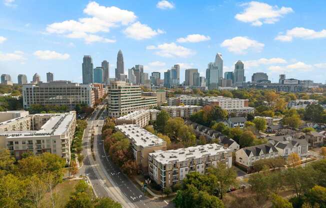 A drone shot overlooking the Charlotte skyline and Ten05 West Trade Apartments.