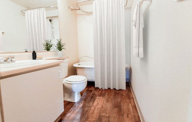 a bathroom with a toilet and a shower curtain