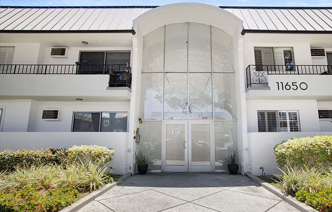 Entrance to National Apartments with drought-resistant greenery.