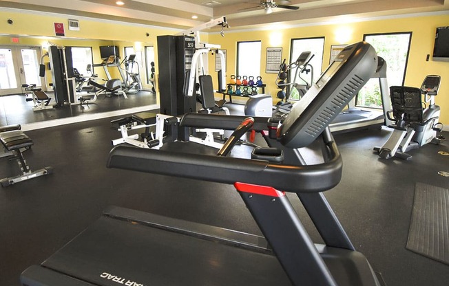 a gym with a treadmill and other exercise equipment