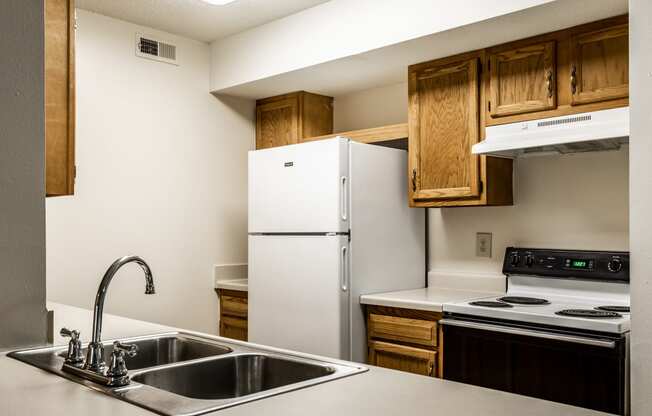 a kitchen with a sink and a refrigerator at Pheasant Run in Lafayette, IN 47909