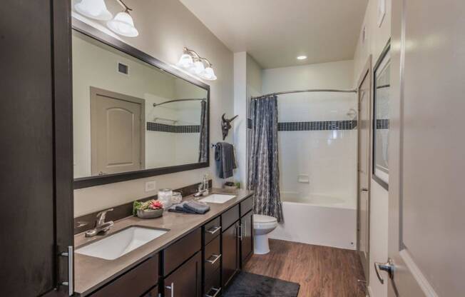 a bathroom with a shower toilet and sink