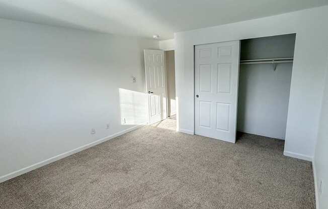 A room with carpeted floor and white walls.
