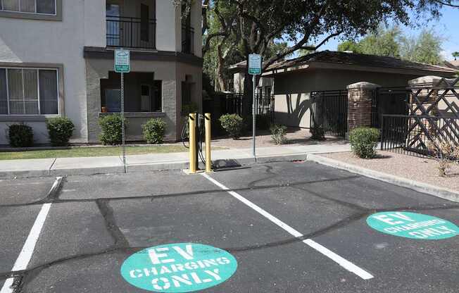 A parking lot with two spots designated for electric vehicles.