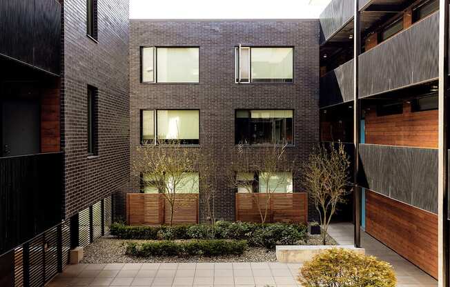 a brick building with a courtyard in front of it