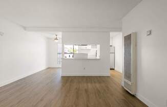 A room with wooden floors and white walls.