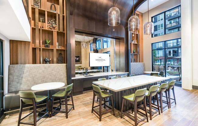 Community dining space with a shared island, arched wood ceiling, and bar seating designed for hosting, casual meals, and welcoming guests.