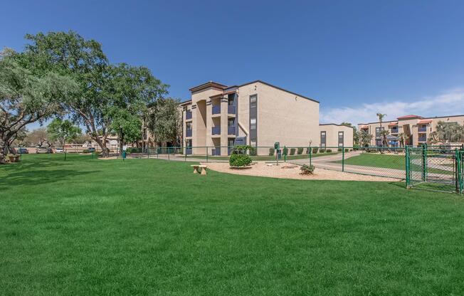 a large green field in front of a building