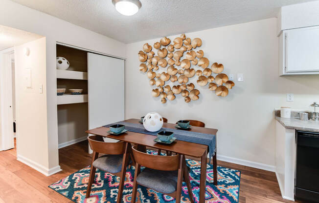 a dining room with a table and chairs