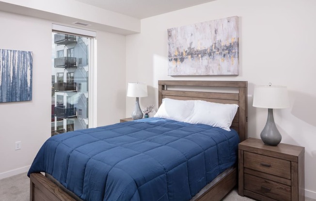 a bedroom with a bed and a painting on the wall at Maven on Broadway, Minnesota, 55904