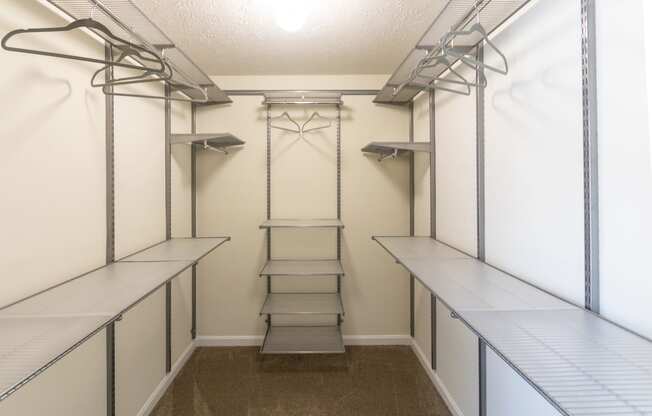 This is a photo of the bedroom walk-in closet with customizable closet system in the upgraded 650 square foot, 1 bedroom model apartment at Deer Hill Apartments in Cincinnati, Ohio.