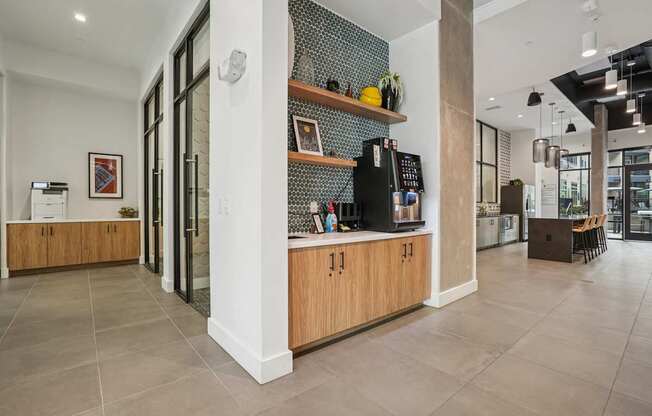 A kitchen with wooden cabinets and a black fridge.