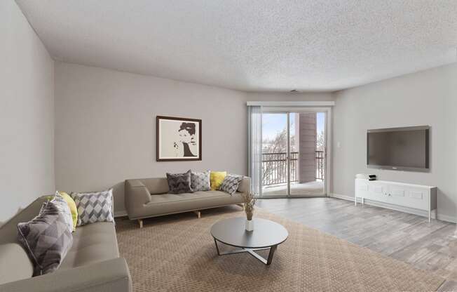 a living room with a couch and a table and a tv  at Eastwood Crossings, Kansas City