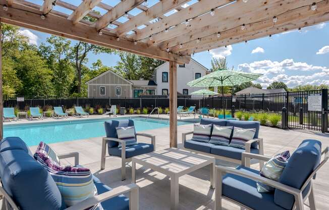 our apartments have a resort style pool with lounge chairs and a pergola