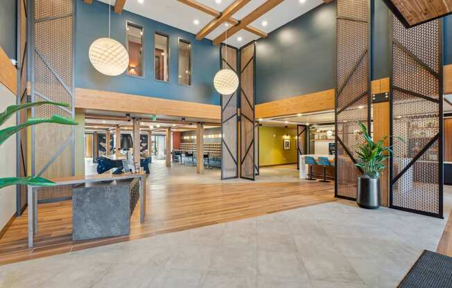 A modern interior with wooden floors and a mix of seating areas.