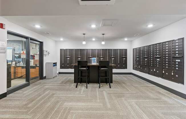 A room with a carpeted floor and a wall of black switches.