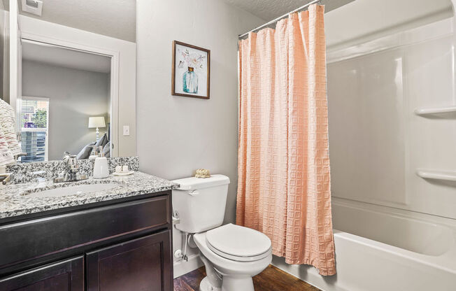 a bathroom with a toilet and a shower and a sink