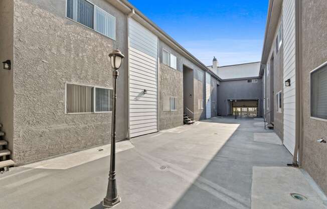 an alleyway between two buildings with a street light