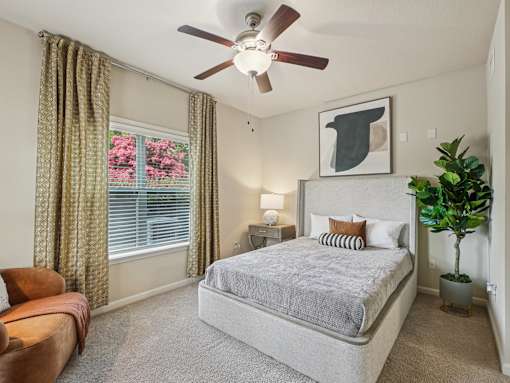 Modern apartment bedroom with natural light at Village at Broadstone Station in Apex, NC