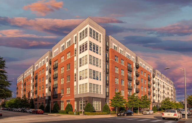 a rendering of a large apartment building on a city street