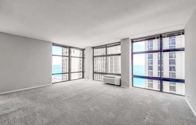 an empty living room with a view of the ocean