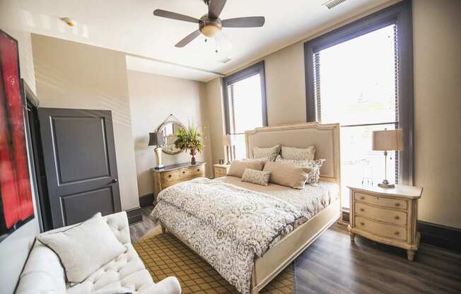 a bedroom with a bed and a ceiling fan at The Knights @ 506 Delaware Apartments, Buffalo, New York