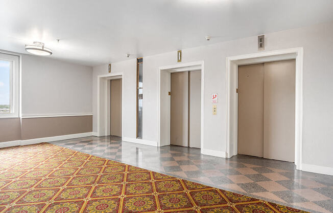 an empty room with four doors in a building