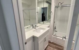 Bathroom with White Cabinets and Bathtub/Shower